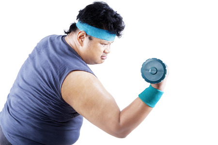 Fat man exercising with a dumbbell. isolated on white backgroundの写真素材