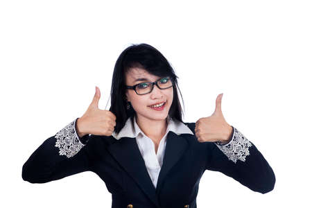 Happy smiling business woman with thumbs up gesture - isolated on white backgroundの写真素材