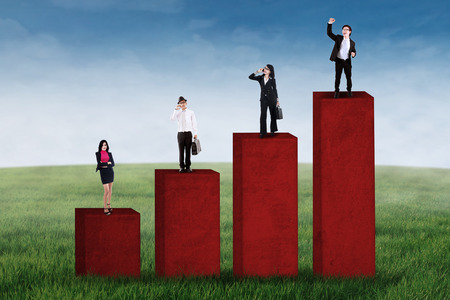 Business growth concept with business group standing on business chartの写真素材