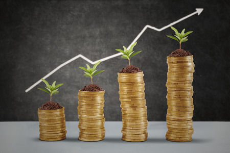 Symbol of business growth with chart made of golden coinの写真素材