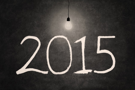 Bright lightbulb illuminate number 2015 on the blackboard