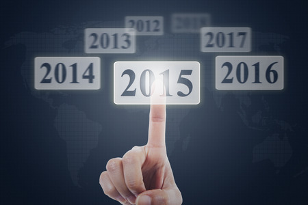 Closeup of hand touching number 2015 on a modern virtual screen