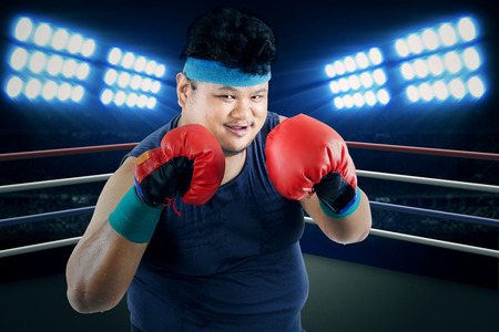 Overweight man ready to boxing on the ringの写真素材
