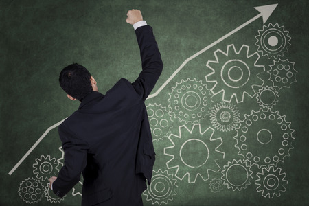 Successful businessman and financial graph on the futuristic screenの写真素材