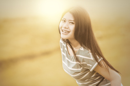 Portrait of attractive woman having fun on the meadow, shot with an filterの写真素材