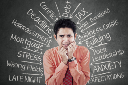Portrait of stressful young businessman getting many pressure of his job problemsの写真素材