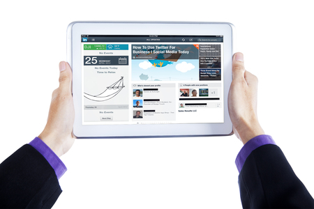 JAKARTA, SEPTEMBER 09, 2015: Closeup of businessperson hands holding digital tablet with twitter webpage for businessのeditorial素材