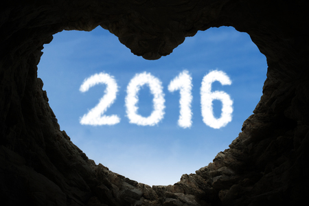 Happy new year concept with a cave shaped heart symbol and numbers 2016 on the sky