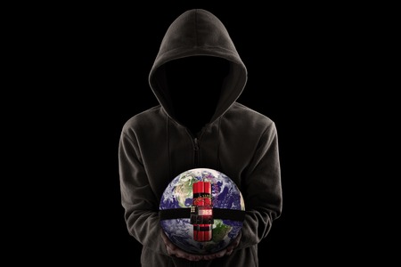 Terrorism concept: Jihadist wearing hoodie and shows a time bomb with globeの写真素材