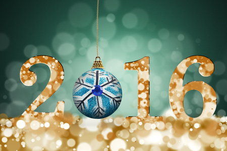 Blue christmas ball and golden numbers of 2016 with bokeh background. New year concept