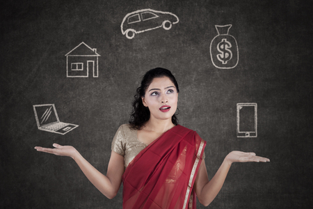 Portrait of a young Indian woman imagines her hopes while wearing saree clothesの写真素材