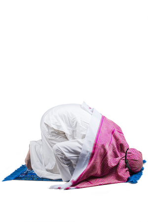 Image of Arabic person wearing islamic clothes and worshiping in the studio with prostration poseの写真素材
