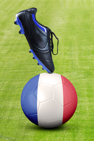 Close up a soccer shoe and ball with France flag on the meadow.の写真素材