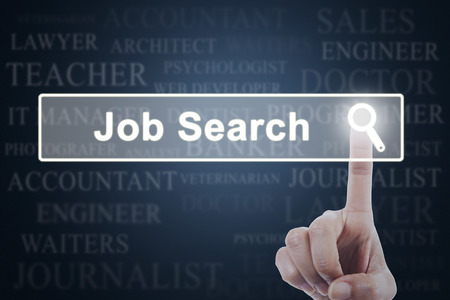 Concept of Job Search with a worker finger pressing a virtual job search button on the futuristic screenの写真素材