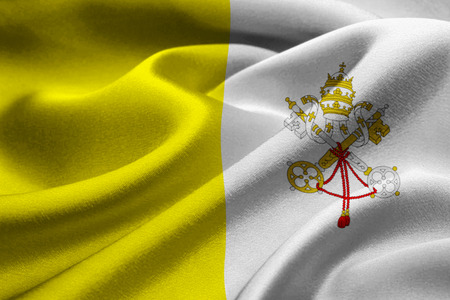 Close up of fabric flag of Vatican City waving in the windの写真素材
