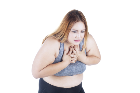 Portrait of obese woman getting heart attack, isolated on white backgroundの写真素材