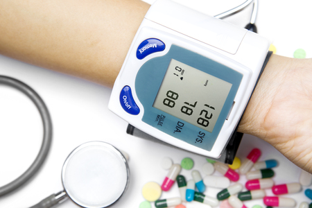 Close up of Isometric Medical Tonometer on the patient hand measuring the heartbeat and blood pressureの写真素材