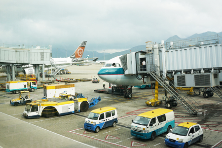HONGKONG, China. April 21, 2017: Airplane is being loaded with cargo in preparation for departure at Hong Kong International Airport.のeditorial素材