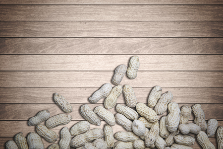 High angle of crunchy groundnuts on the wooden background, concept of healthy foodの写真素材
