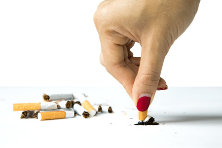 Woman destroying a cigarette in her hand, concept of refuse bad habit, isolated on white backgroundの写真素材