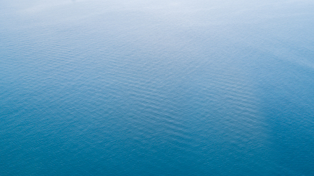 Top view of beautiful blue ocean with ripples on the surface of the sea water