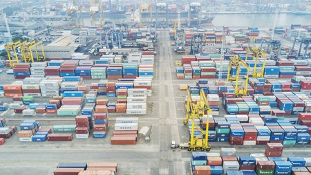 JAKARTA, Indonesia. July 10, 2017: Aerial view of cranes and stacked containers in industrial port...