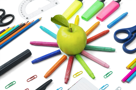 Image of fresh apple with multicolored school supplies, isolated on white backgroundの写真素材