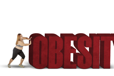 Image of fat woman wearing sportswear while pushing obesity word, isolated on white backgroundの写真素材