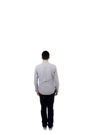 Back view of young man wearing casual clothes and standing in the studio, isolated on white backgroundの写真素材