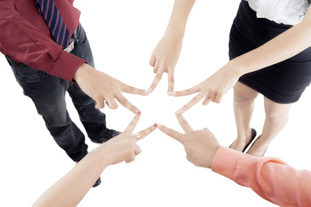 Picture of business people making a star with their fingers, isolated on white backgroundの写真素材