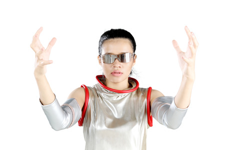 Beautiful futuristic woman holding something with two palms while wearing silver latex costume and...