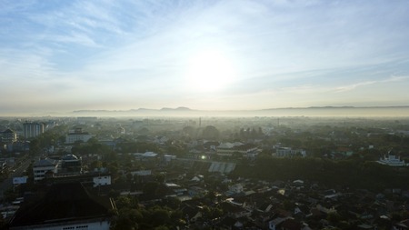 Picture of beautiful sky above crowded residential house with mist at Semarang, Indonesiaのeditorial素材