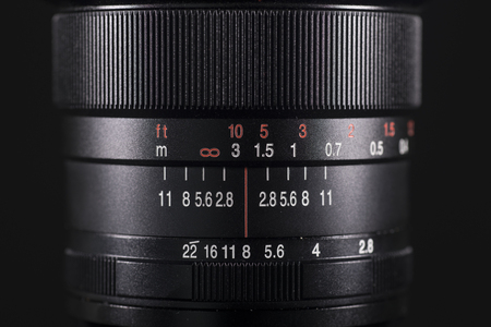 Closeup of a professional lens for digital camera with dark backgroundの写真素材