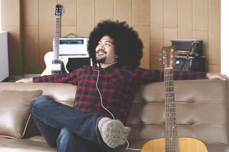 Thinking musician looking up in recording studio