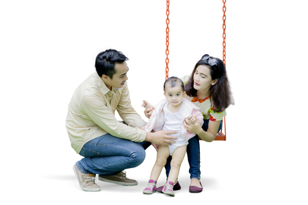 Asian family playing with swing isolated over white backgroundの写真素材