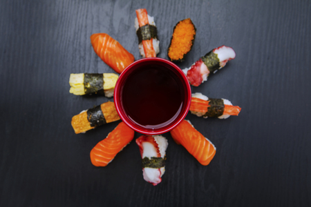 High angle view of assorted sushi with soy sauce on the tableの写真素材