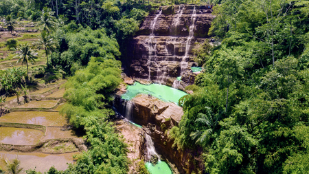 Aerial view of tourists enjoying scenery of exotic Cigangsa waterfall in Sukabumi, West Java,...