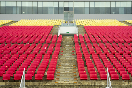 Singapore. February 15, 2018: rows of red and yellow bleachers in the football stadiumのeditorial素材