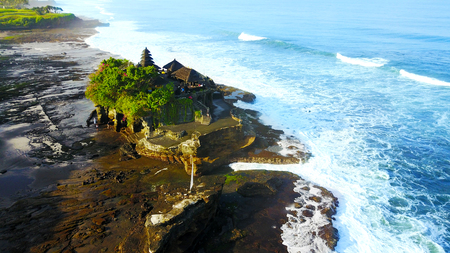 BALI, INDONESIA. APRIL 23, 2018: Aerial view of beautiful Tanah Lot temple with frothy wave in Bali, Indonesiaのeditorial素材