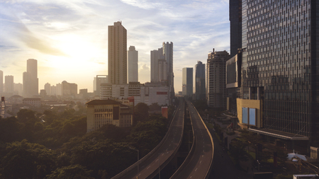 JAKARTA - Indonesia. May 21, 2018: Aerial view of skyscrapers with highway overpass in Jakarta at sunrise timeのeditorial素材