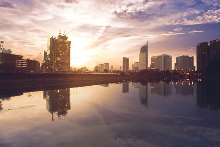 JAKARTA - Indonesia. MAY 31, 2018: Beautiful scenery of water reservoir with skyscrapers at sunrise time in Jakarta, Indonesiaのeditorial素材