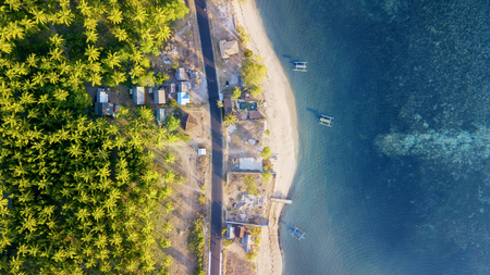 Top view of beautiful beach with boats on turquoise water. Shot in Lombok, Indonesiaの写真素材