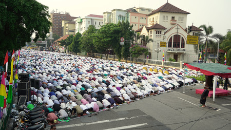JAKARTA - Indonesia. September 18, 2018: Crowded Muslim people praying together on Eid Al Adha day near Koinonia Church in Jakarta, Indonesiaのeditorial素材