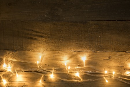 Christmas lights shot with copy space on vintage wooden backgroundの写真素材