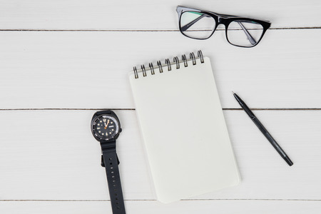 High angle view of blank paper notes with glasses and wristwatch on the table. Father's day conceptの写真素材