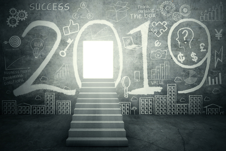 Image of stairway toward shining door with number 2019 and scribbles on the wall