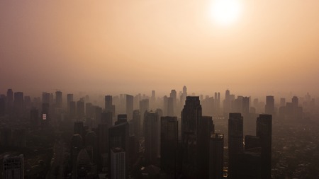 JAKARTA, Indonesia - October 11, 2018: Aerial view of Jakarta skyline at dusk with silhouette of skyscrapersのeditorial素材