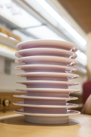 Closeup of empty dishes piling on the wooden table after lunchの写真素材