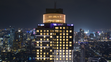 JAKARTA - Indonesia. October 22, 2018: Aerial scenery of beautiful skyscraper with glowing light on windows at night in Jakartaのeditorial素材