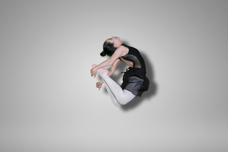 Picture of a young female ballet dancer doing elegant leaps in the studioの写真素材
